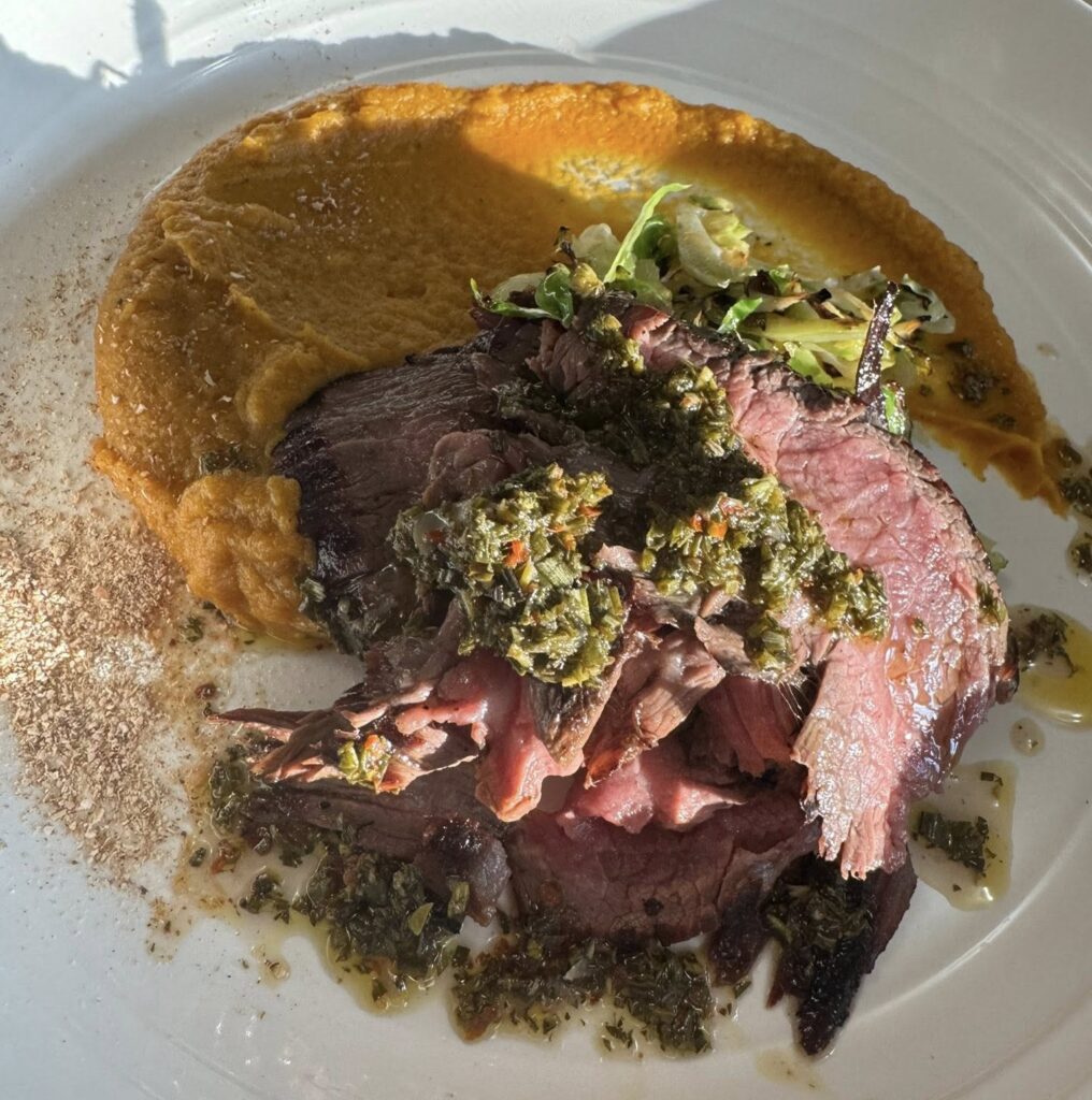 Plated steak entrée prepared by private chef for graduation party catering in Indianapolis