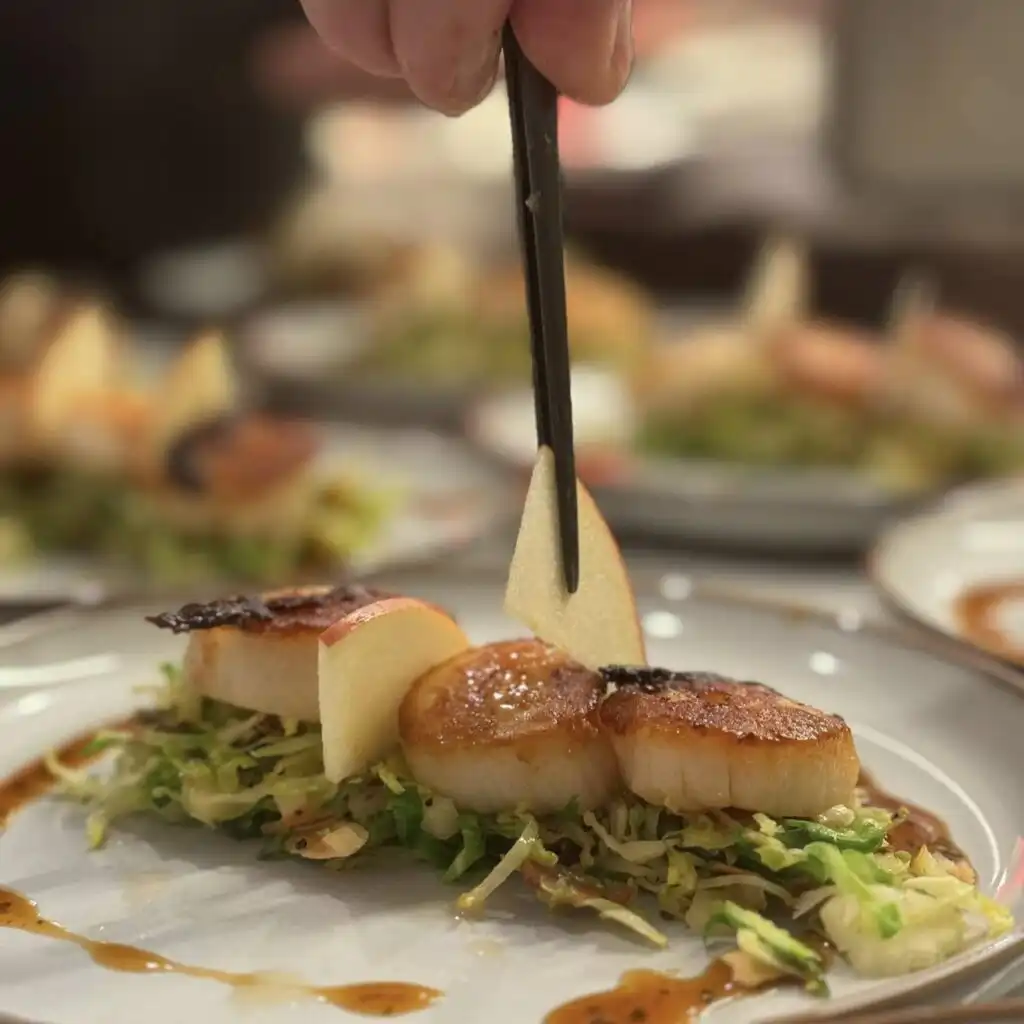 Chef plating a gourmet entrée for a personal chef birthday dinner by Chefski