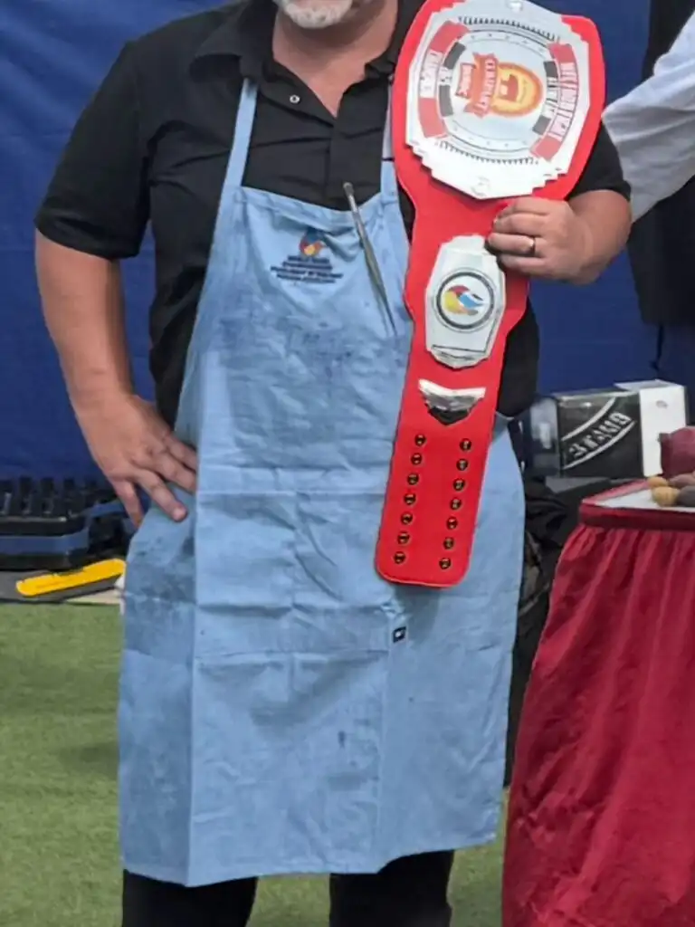 Chef Chefski holding Indiana Pork belt championship award at culinary competition