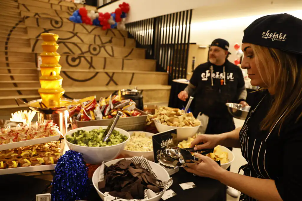 Guests enjoying interactive dessert station with chocolate fountain at NCAA corporate catering event in Indianapolis