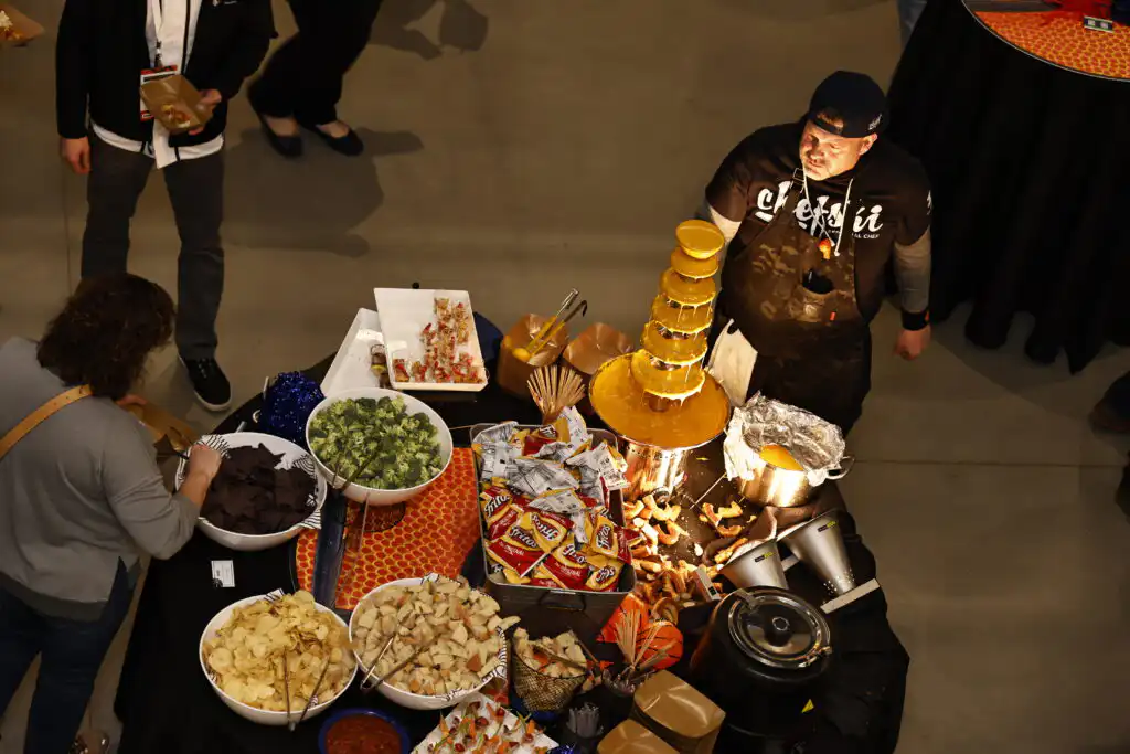 Guests enjoying buffet-style catering service at NCAA corporate event in Indianapolis by Chefski