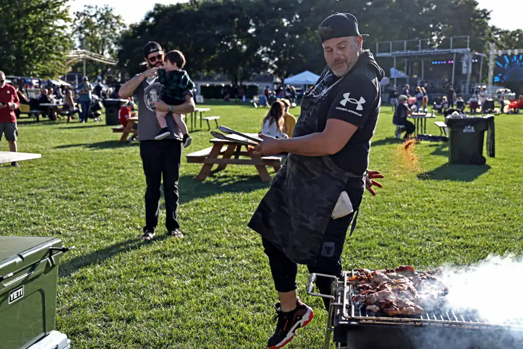 Chef Shelby serving guests at a luxury outdoor catering event in Indianapolis