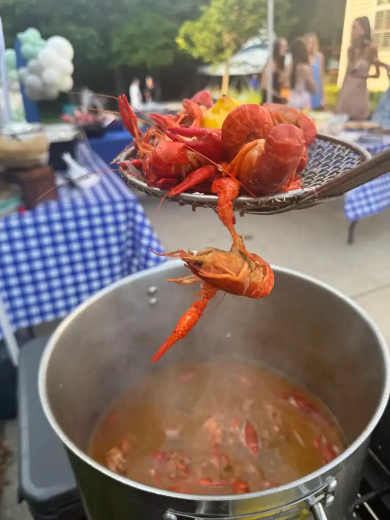 Chef Shelby glazing barbecue with signature sauce during a luxury backyard BBQ catering event